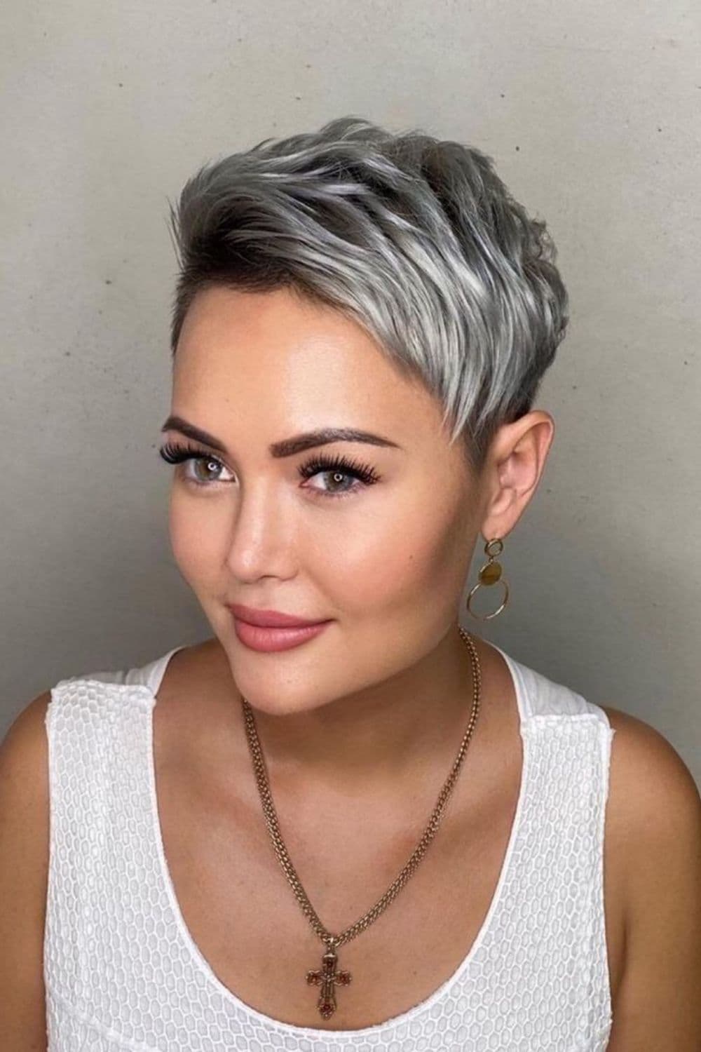 A woman with black and gray hair in a classic pixie cut.