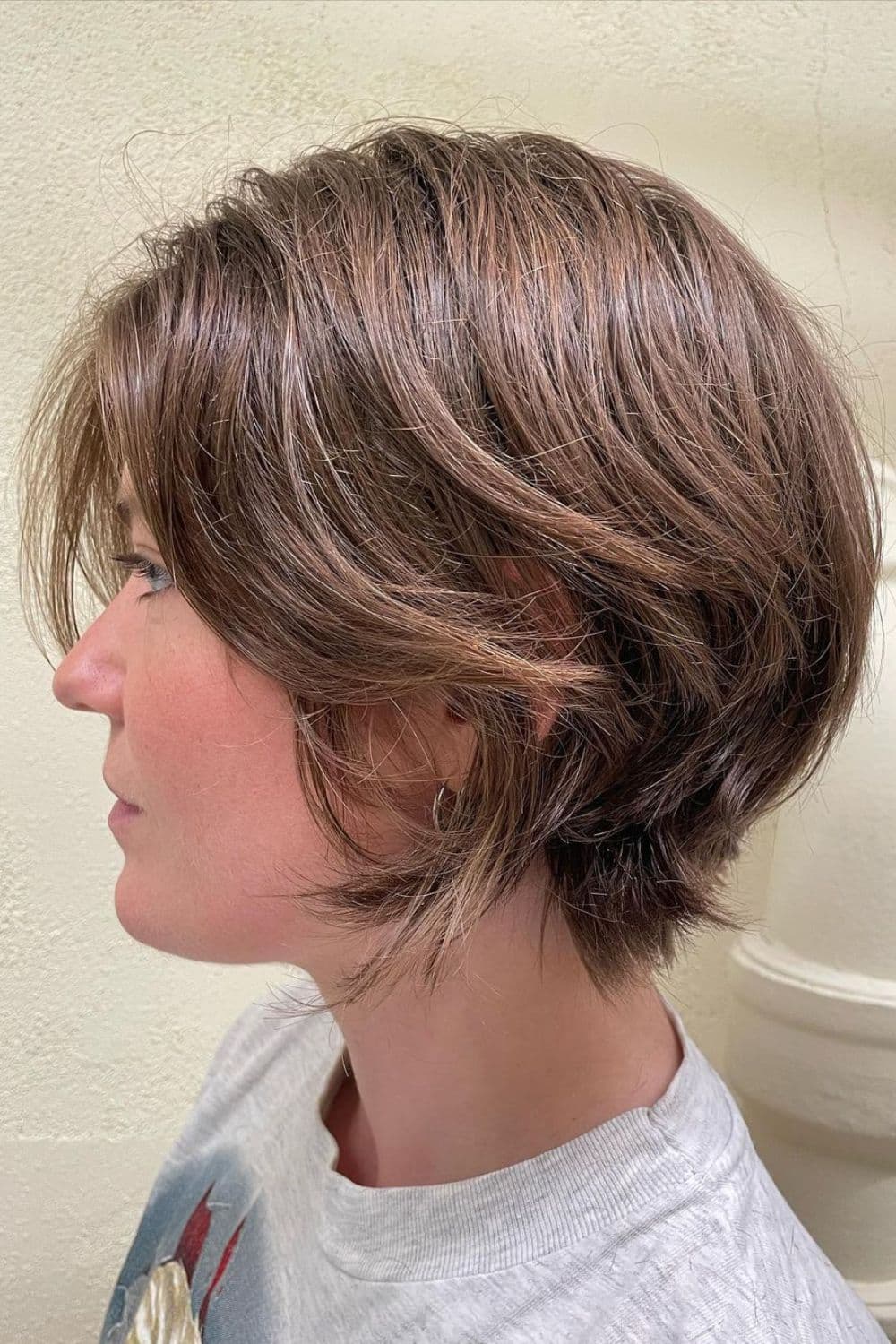 Side view of a woman with a classic short layered cut.