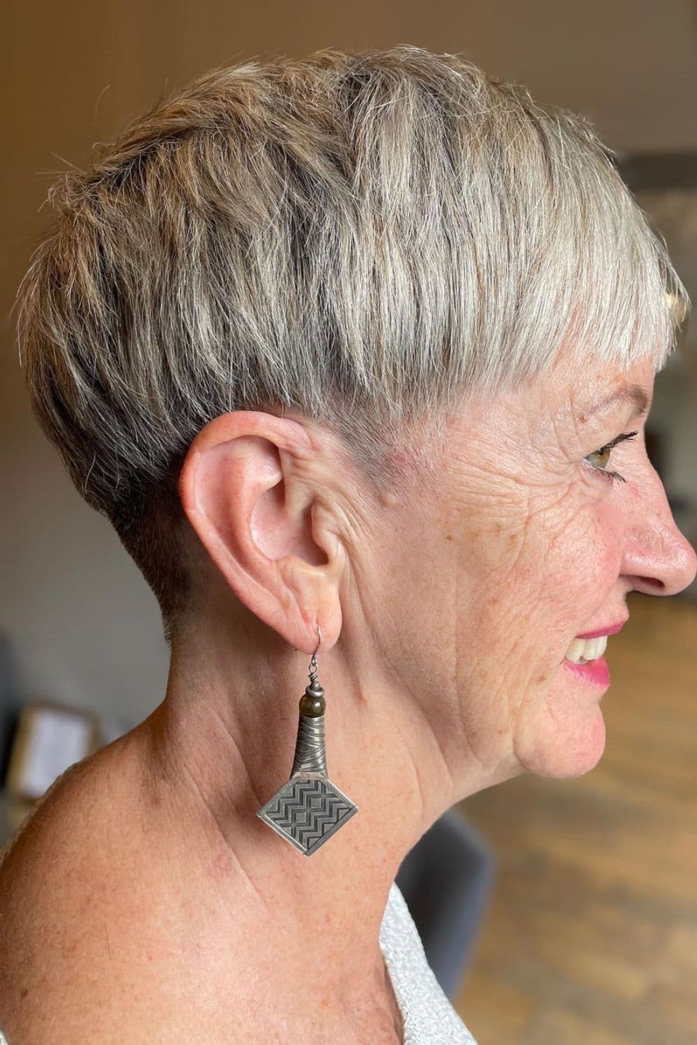 A woman with a gray, textured crop cut.