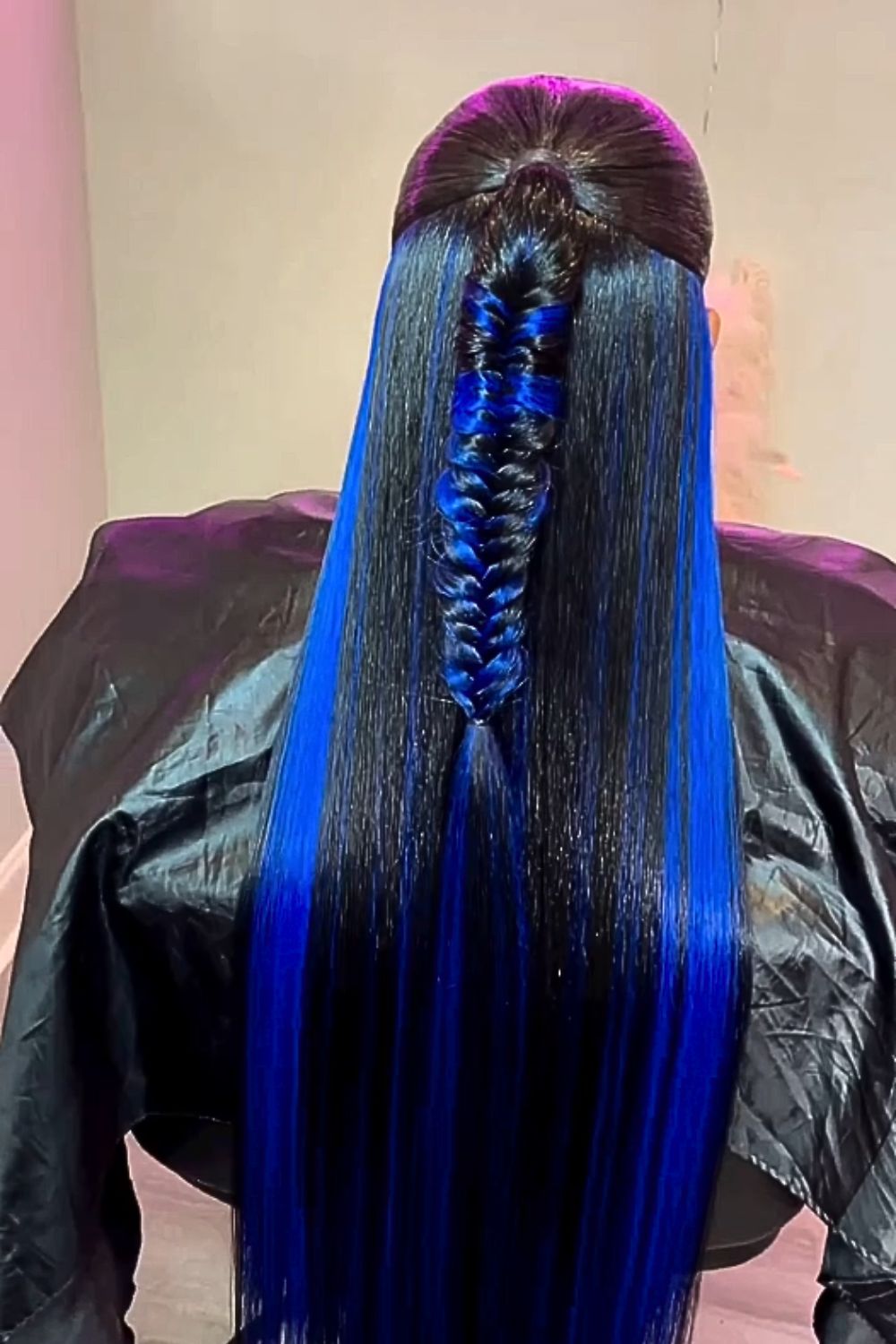 A woman with black and blue fishtail braids.