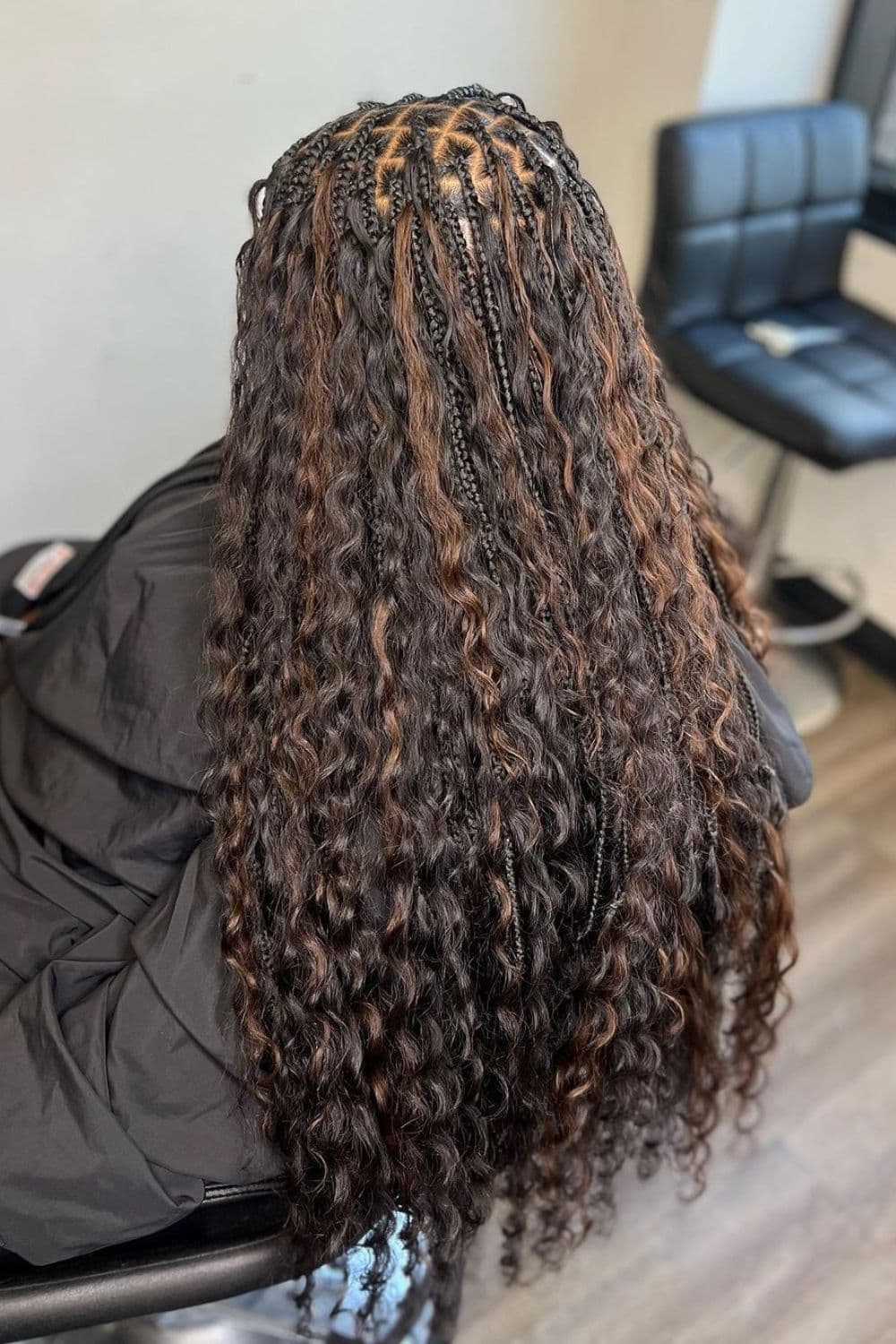 A woman's hair with black and brown goddess braids.