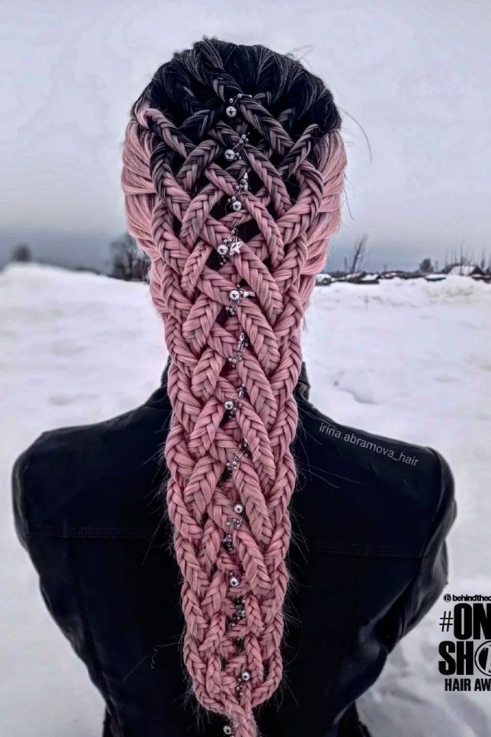 A mannequin with black and pink fishtail braids.