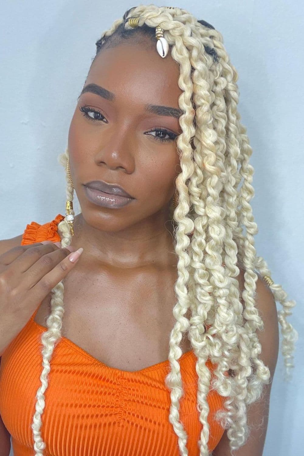A woman with blonde passion twists.
