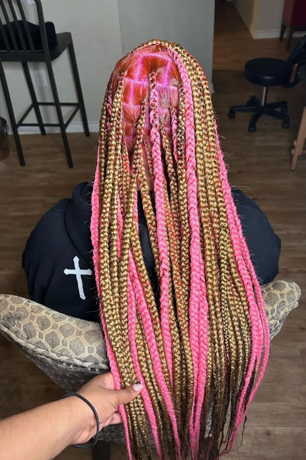 A woman with blonde and pink knotless braids.
