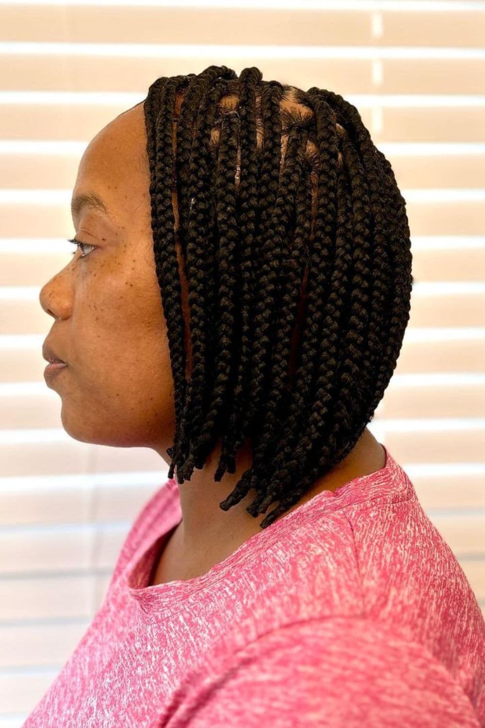 Side view of a woman with box braids bob.