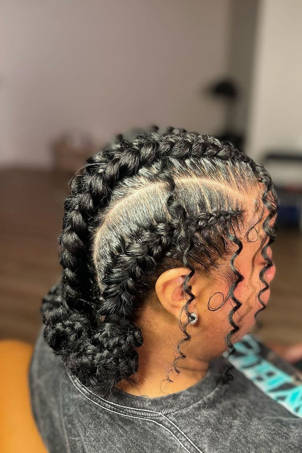 Side view of a woman with butterfly braid low bun with some curls.