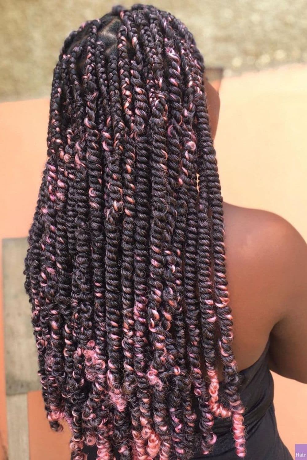 A woman's hair in black and pink chunky passion twists.