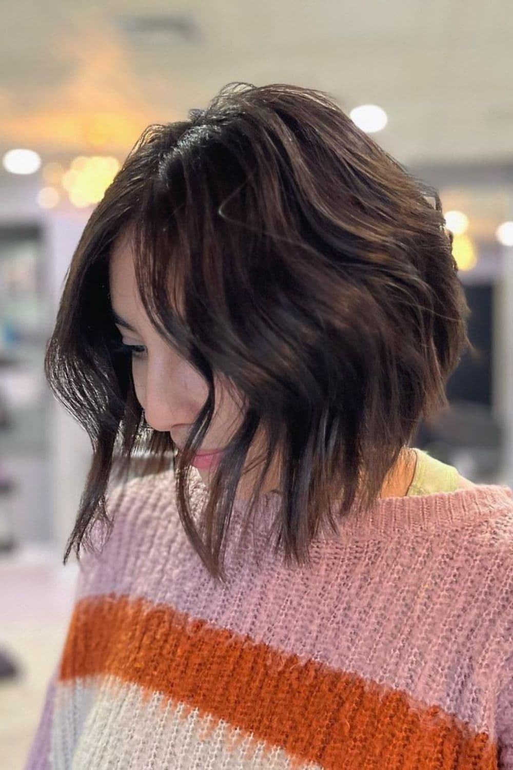 A woman wearing a knitted sweater with classic wavy lob.