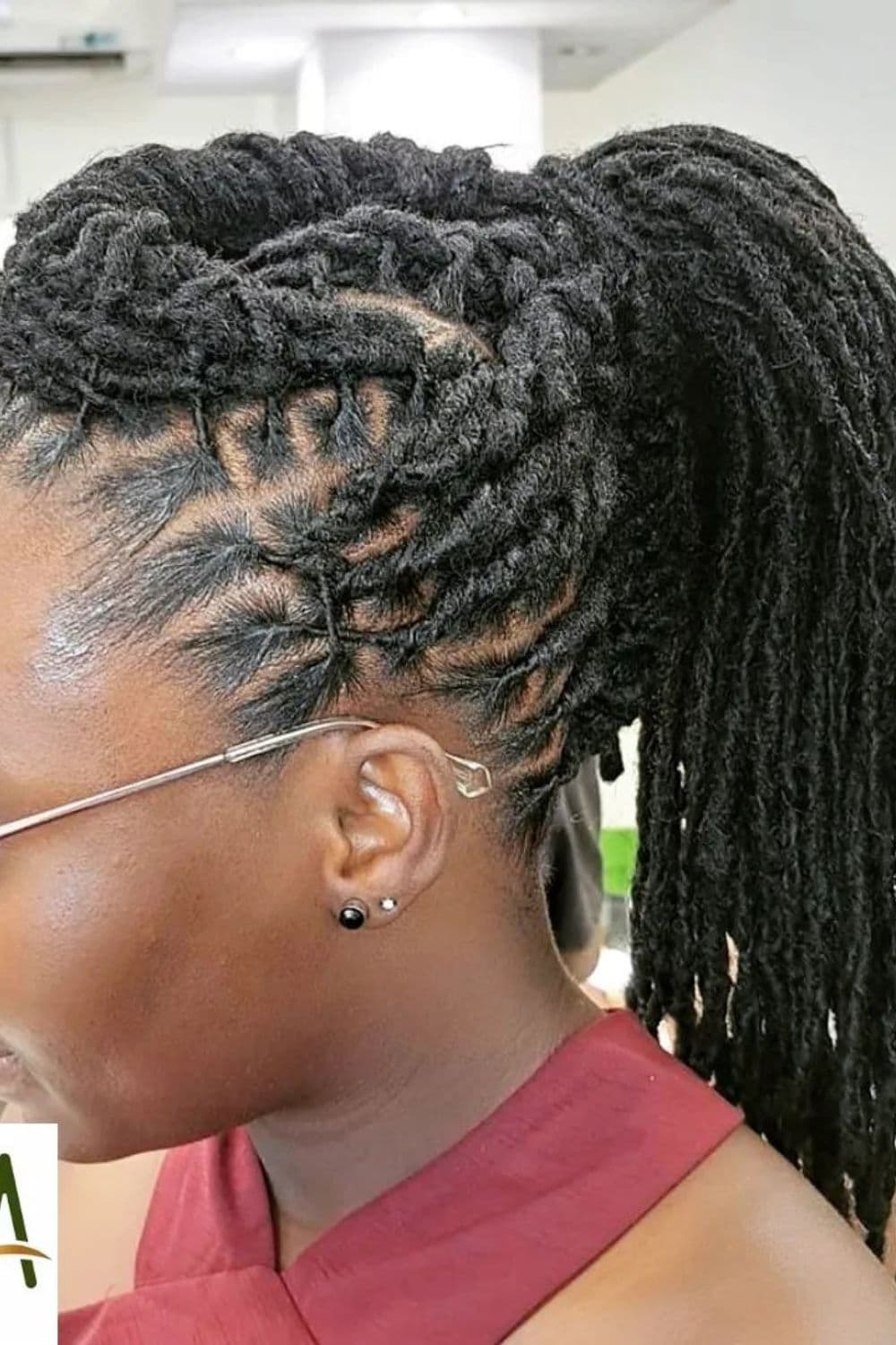 Side view of a woman with a black comb twist comb in a ponytail.
