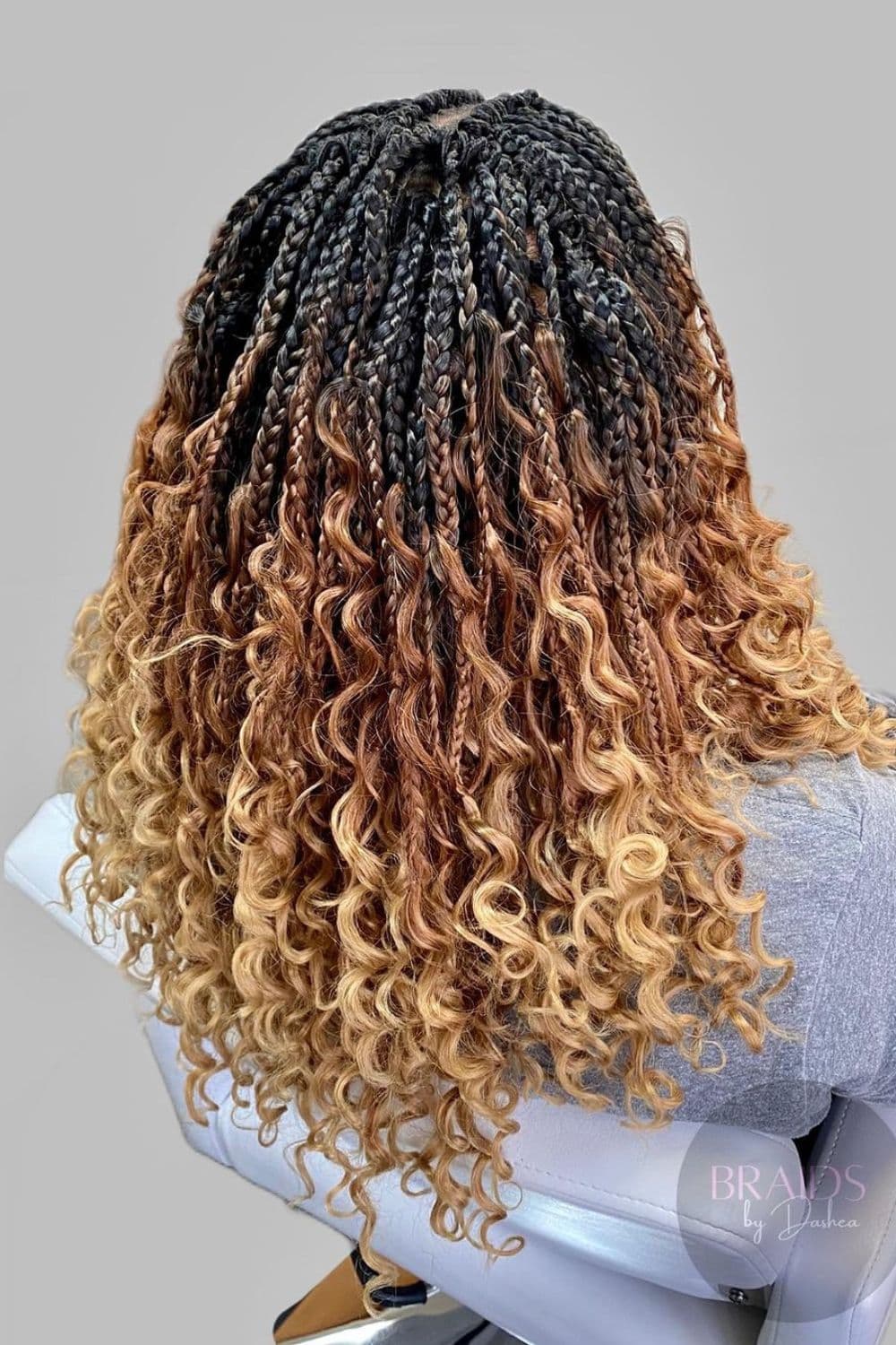 A woman's back with ombre crochet Bohemian braids.