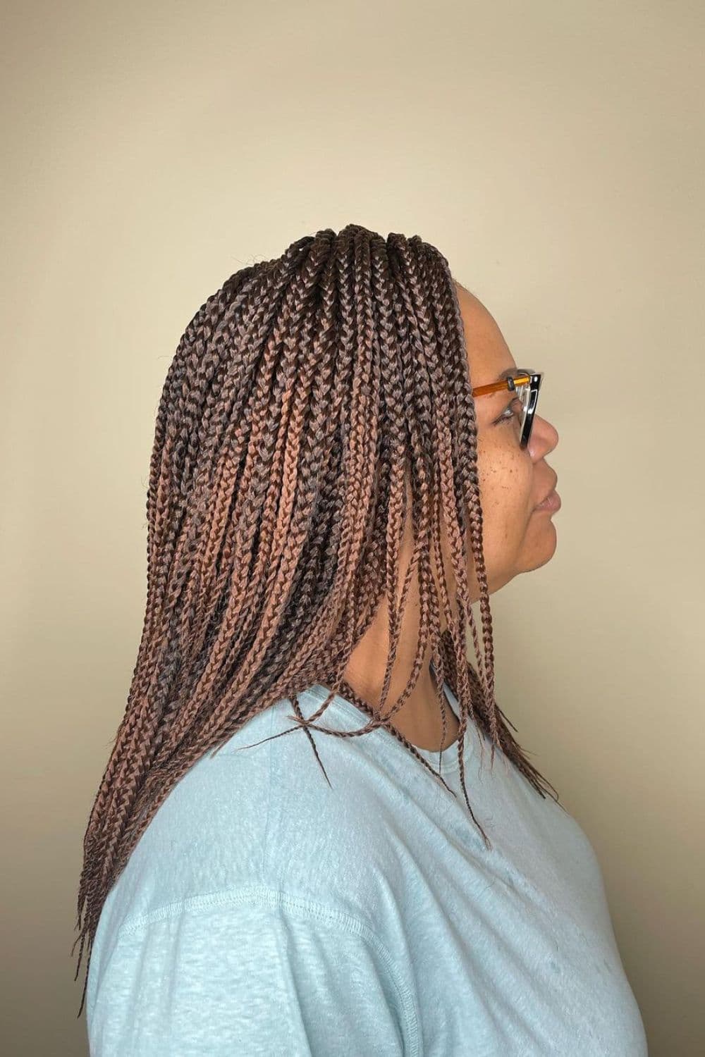Side view of a woman with brown crochet box braids.