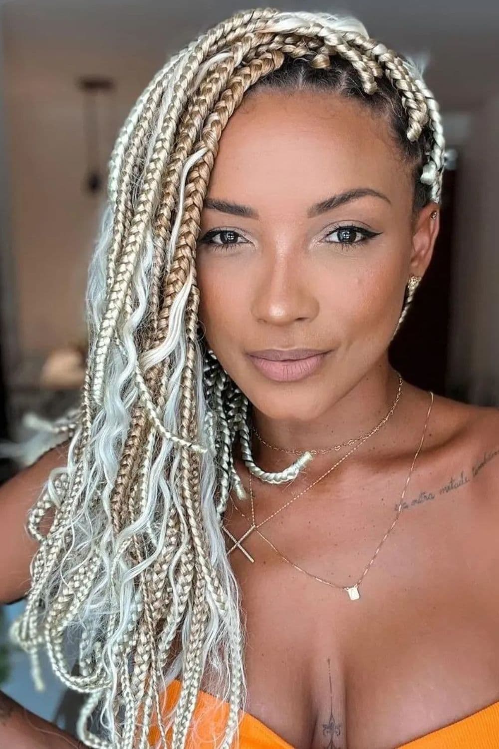 A woman with platinum and blonde crochet braids.