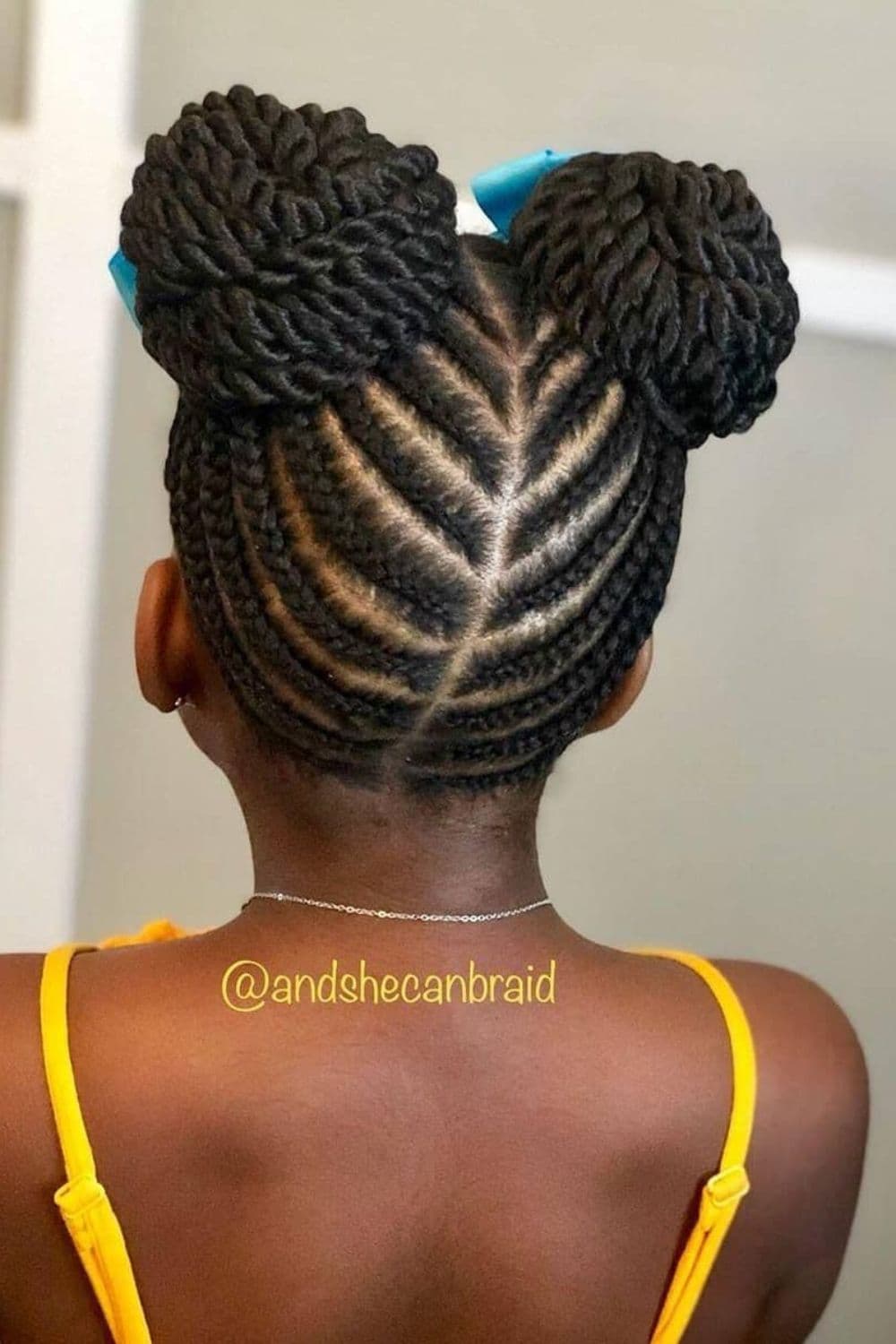 Back of a girl with black crochet space buns.