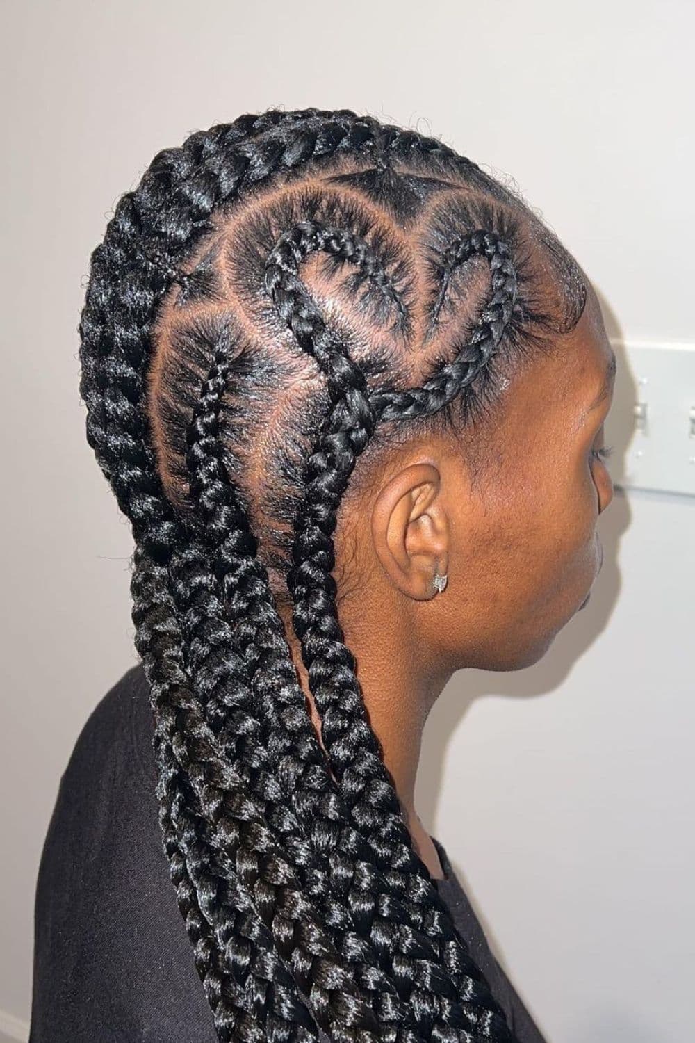 Side view of a woman with heart feed-in braids.