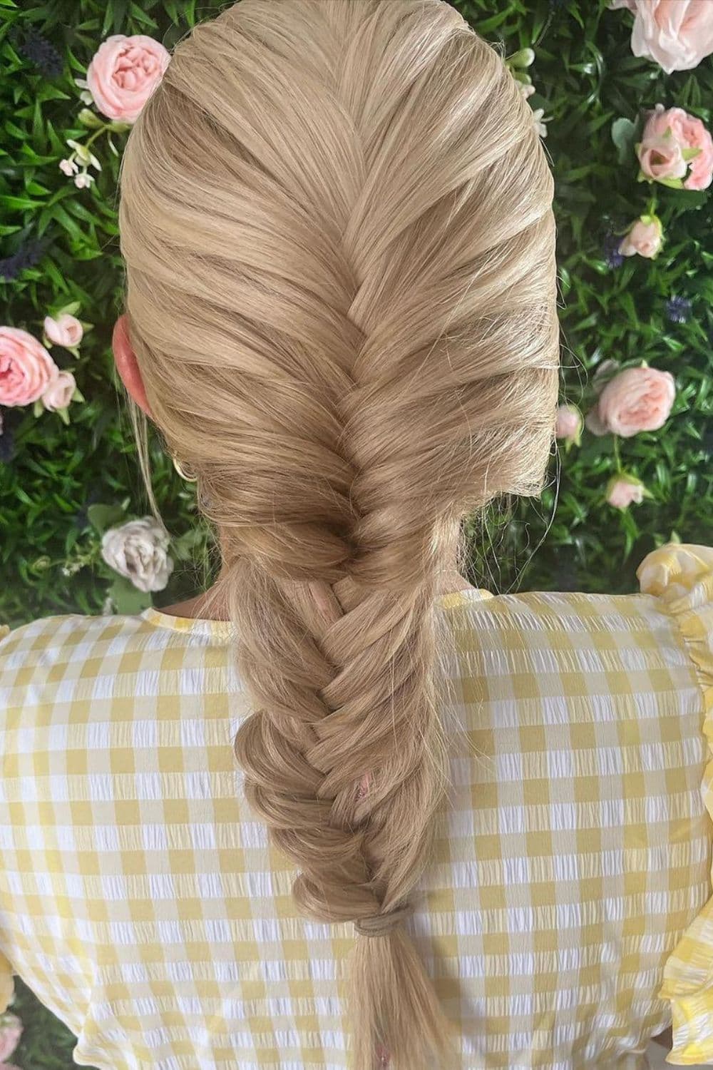 A woman with blonde fishtail braids.