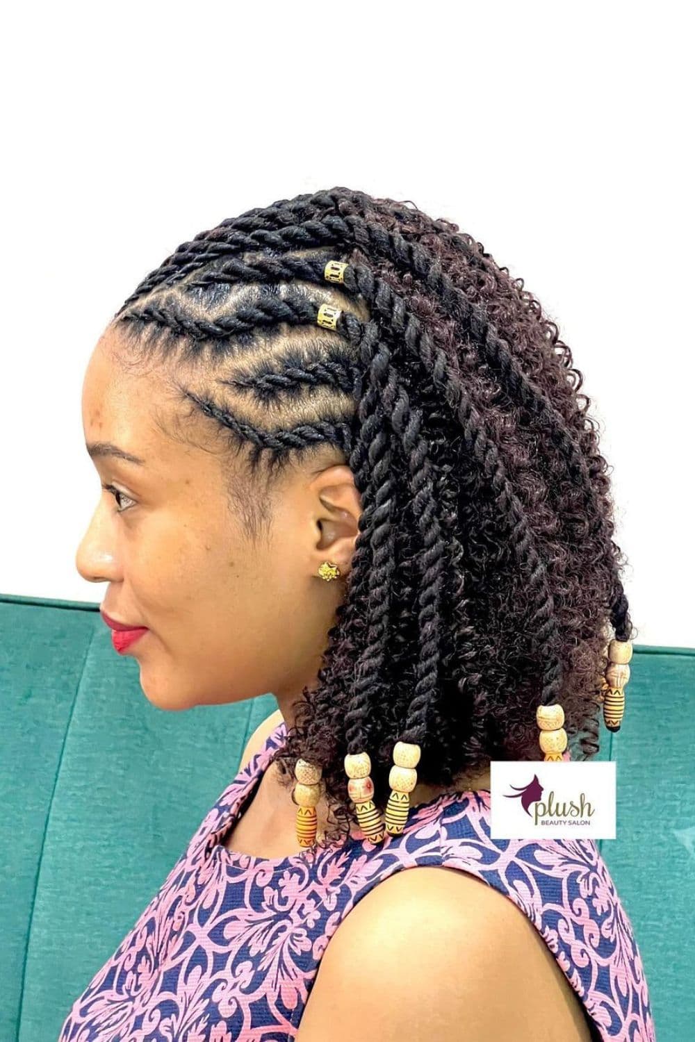 Side view of a woman with black flat twists hairstyle with beads and gold cuffs.