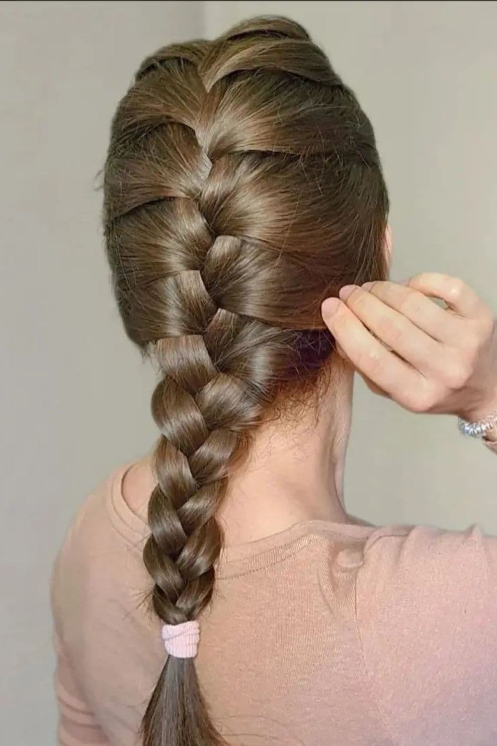 A woman with brown French braids.