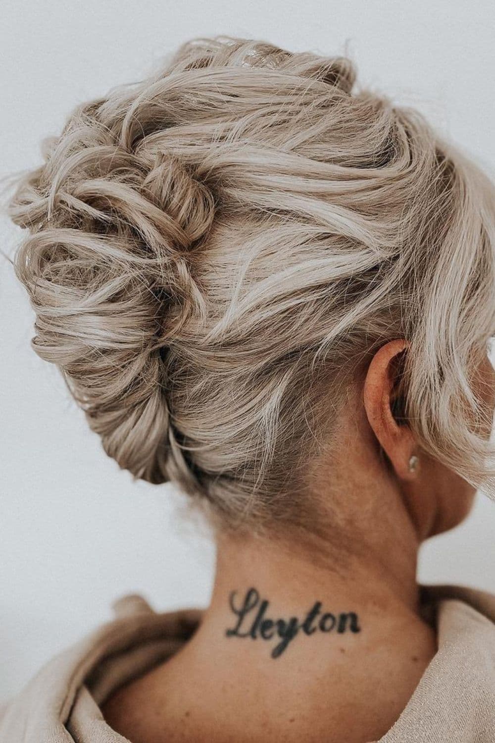 Side view of a woman with a white French twist.
