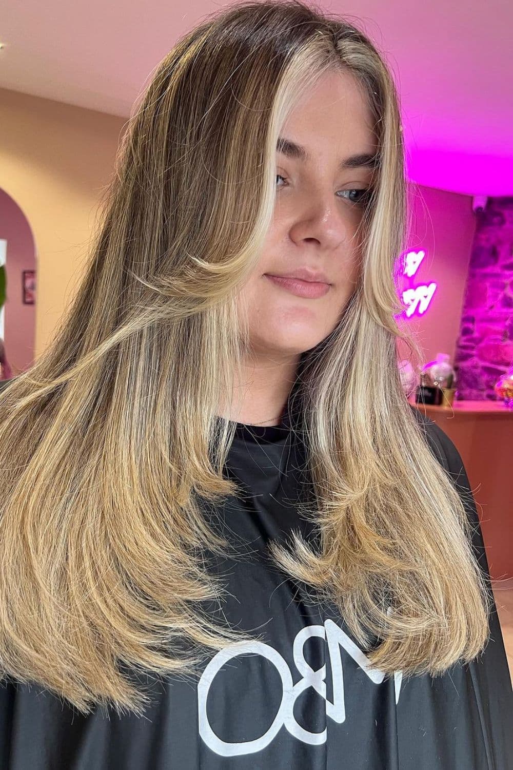 A woman with front layers with long hair balayage.
