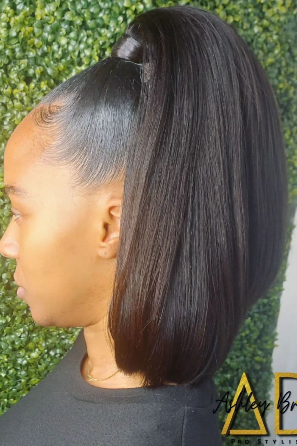 Side view of a woman with half up half down bob.