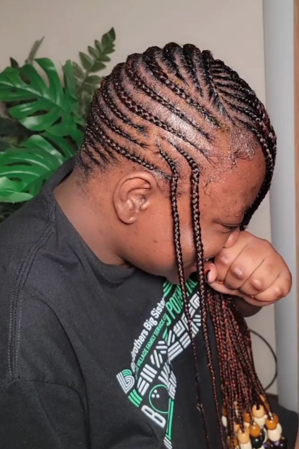 Side view of a person with lemonade braids with beads.