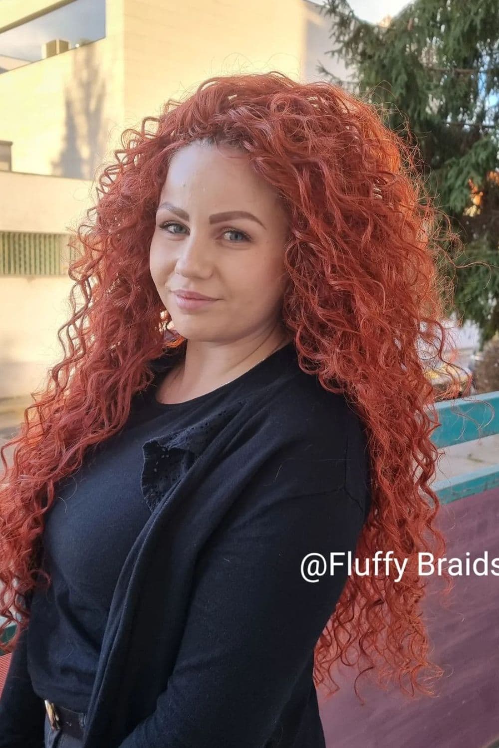 A woman with red long crochet curls.