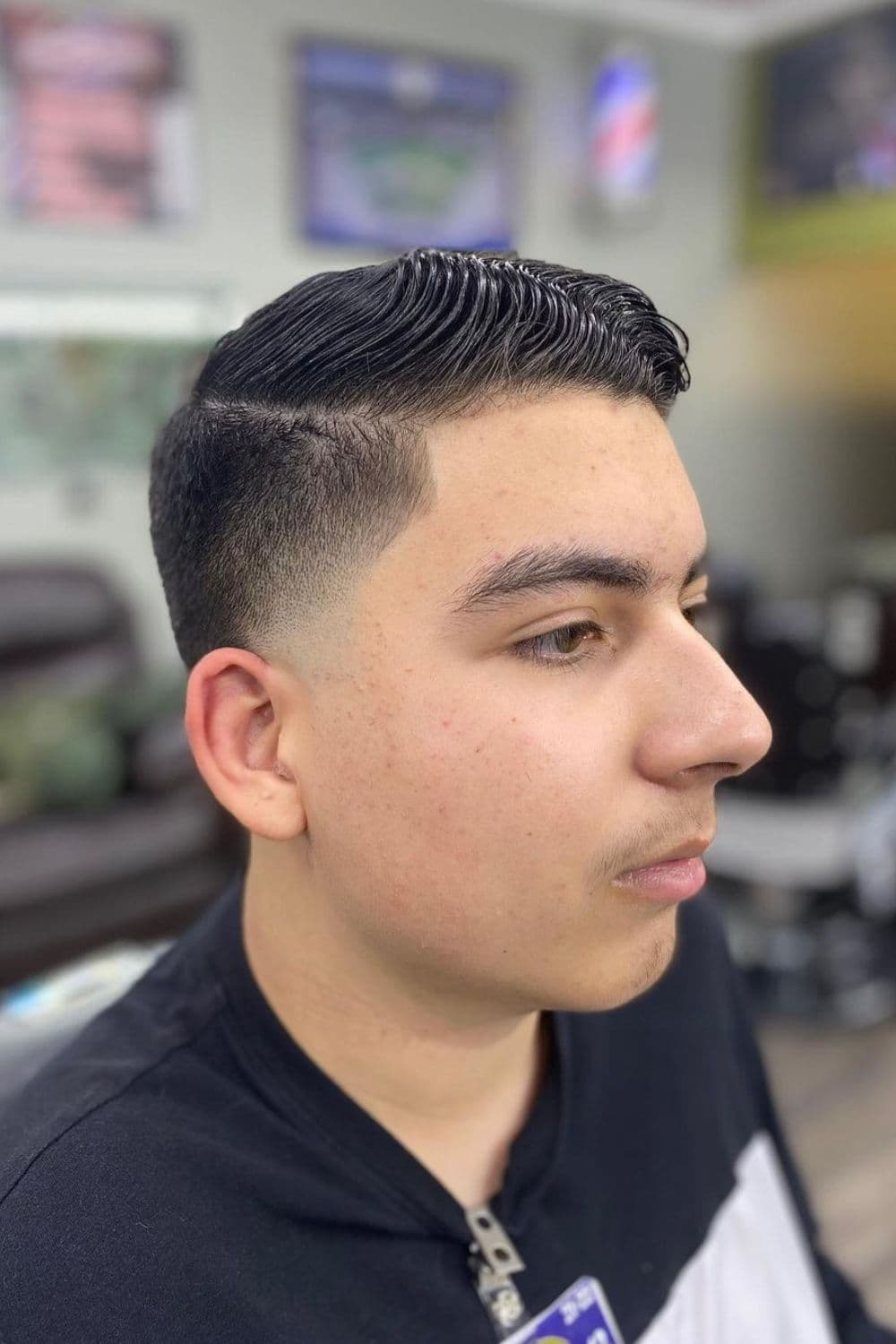 Side view of a man with low taper comb over.