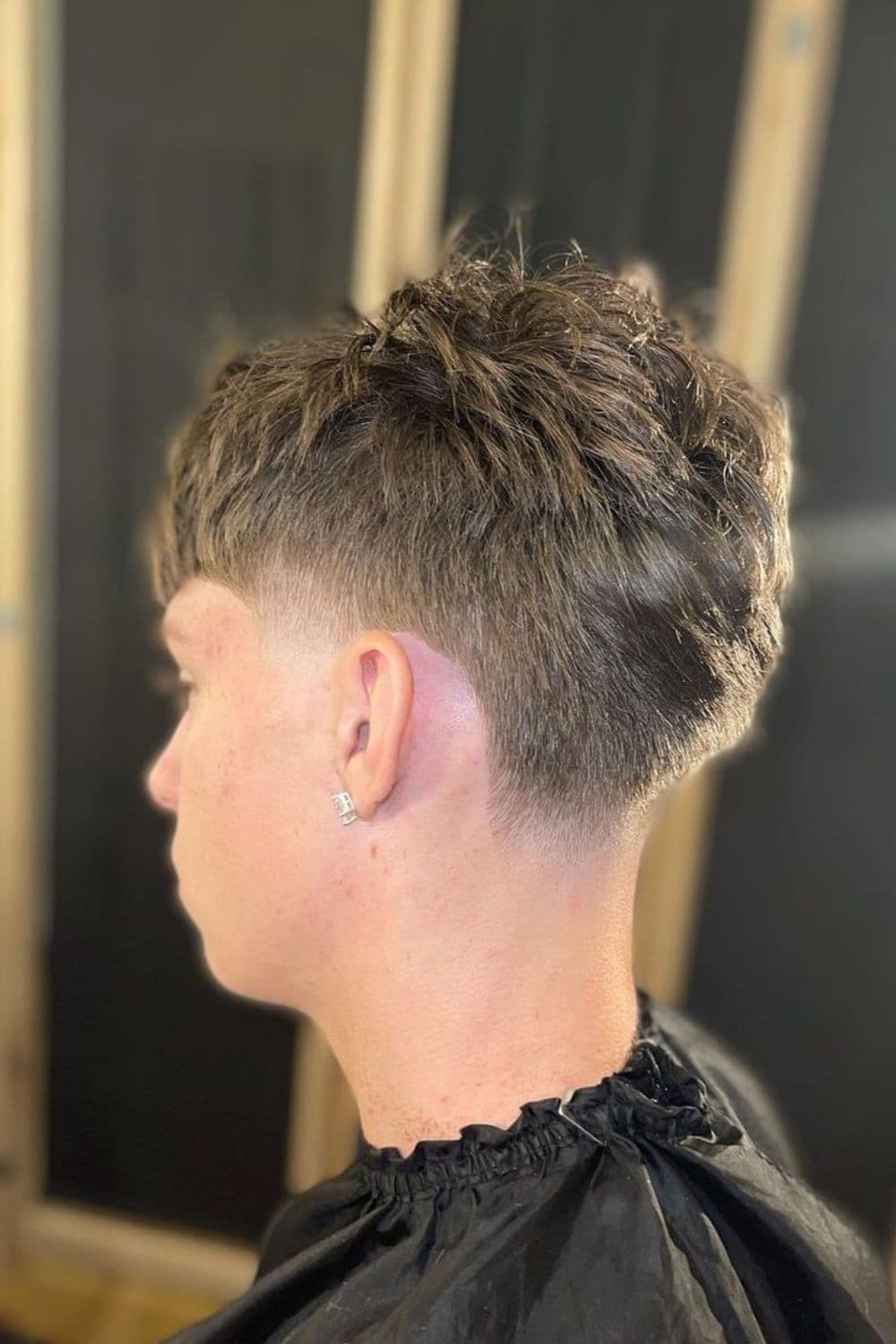 Side view of a man with low taper Edgar cut.