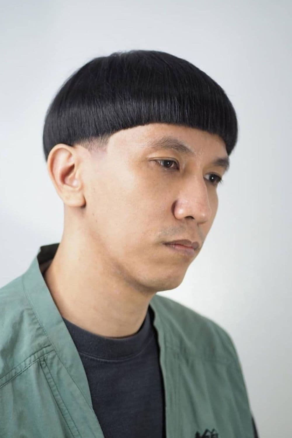 A man with low taper fade bowl cut.