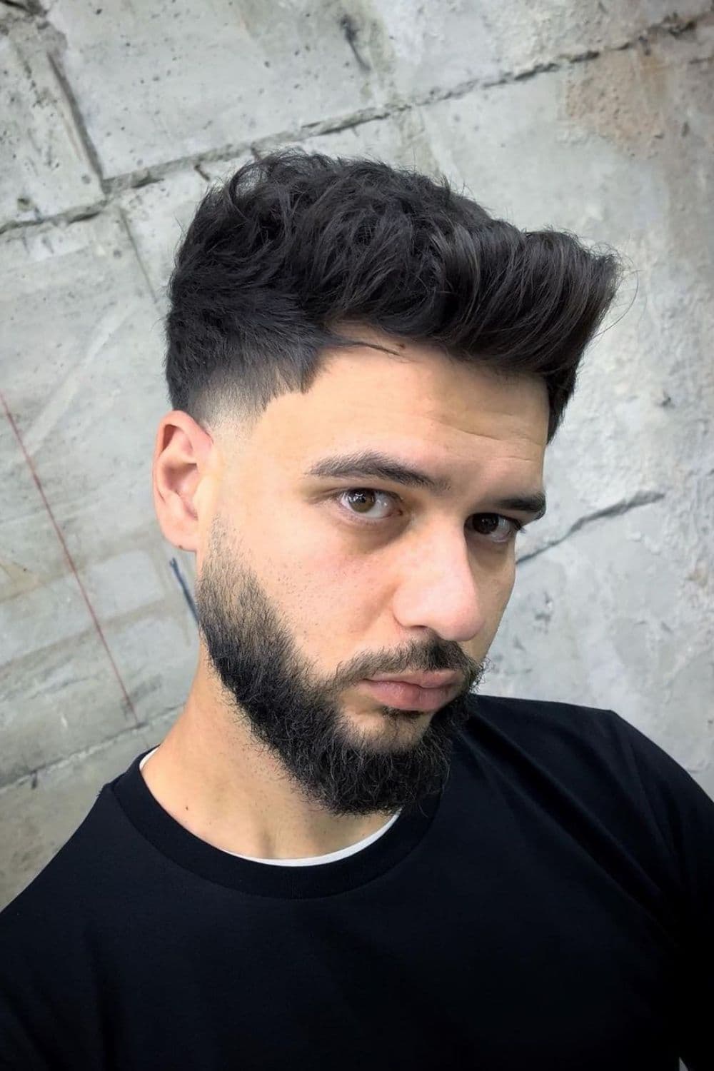 A man with low taper fade with square top.