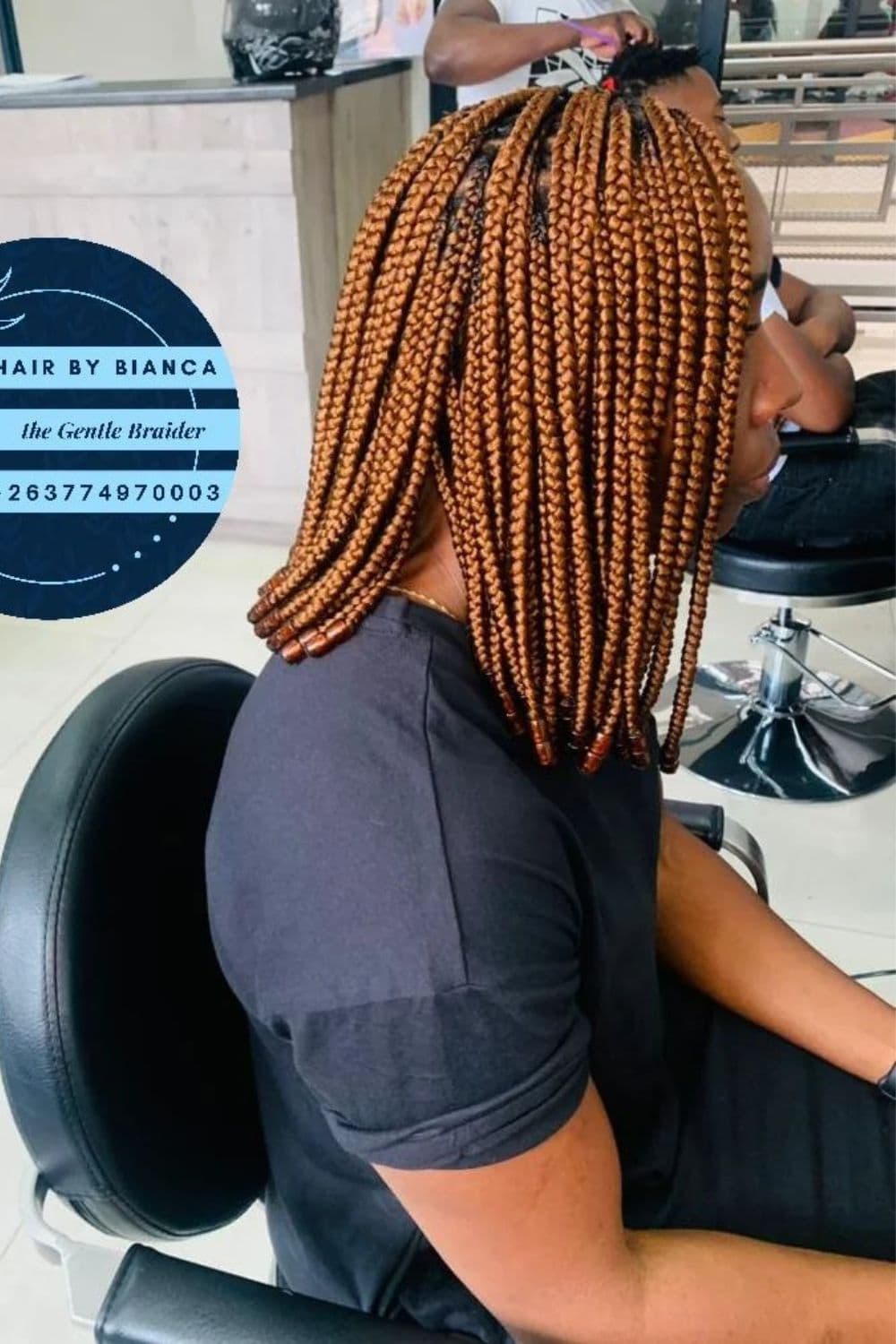 Side view of a woman with brown medium knotless braids bob.