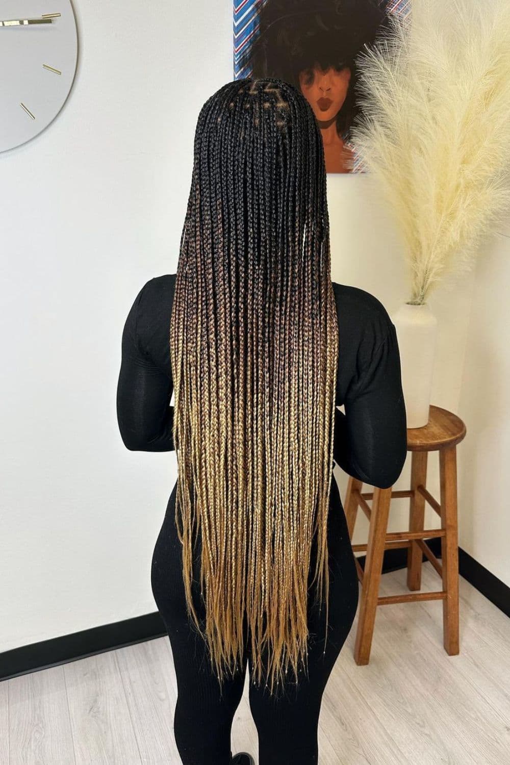 A woman with medium knotless braids and blonde ombre.
