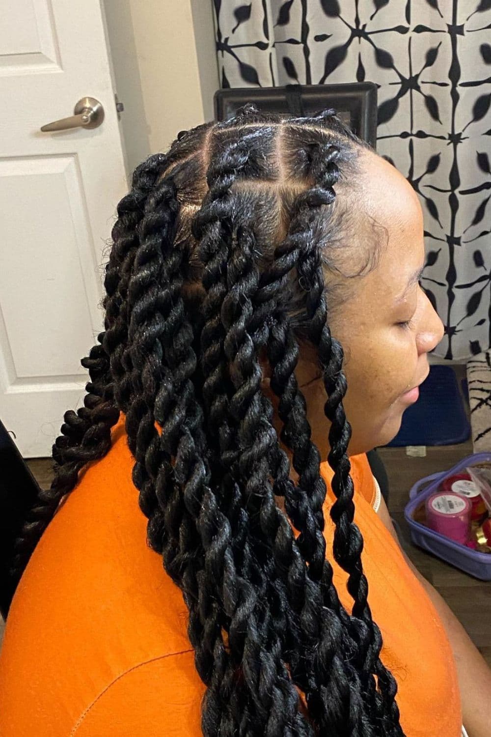 Side view of a woman with medium twists.