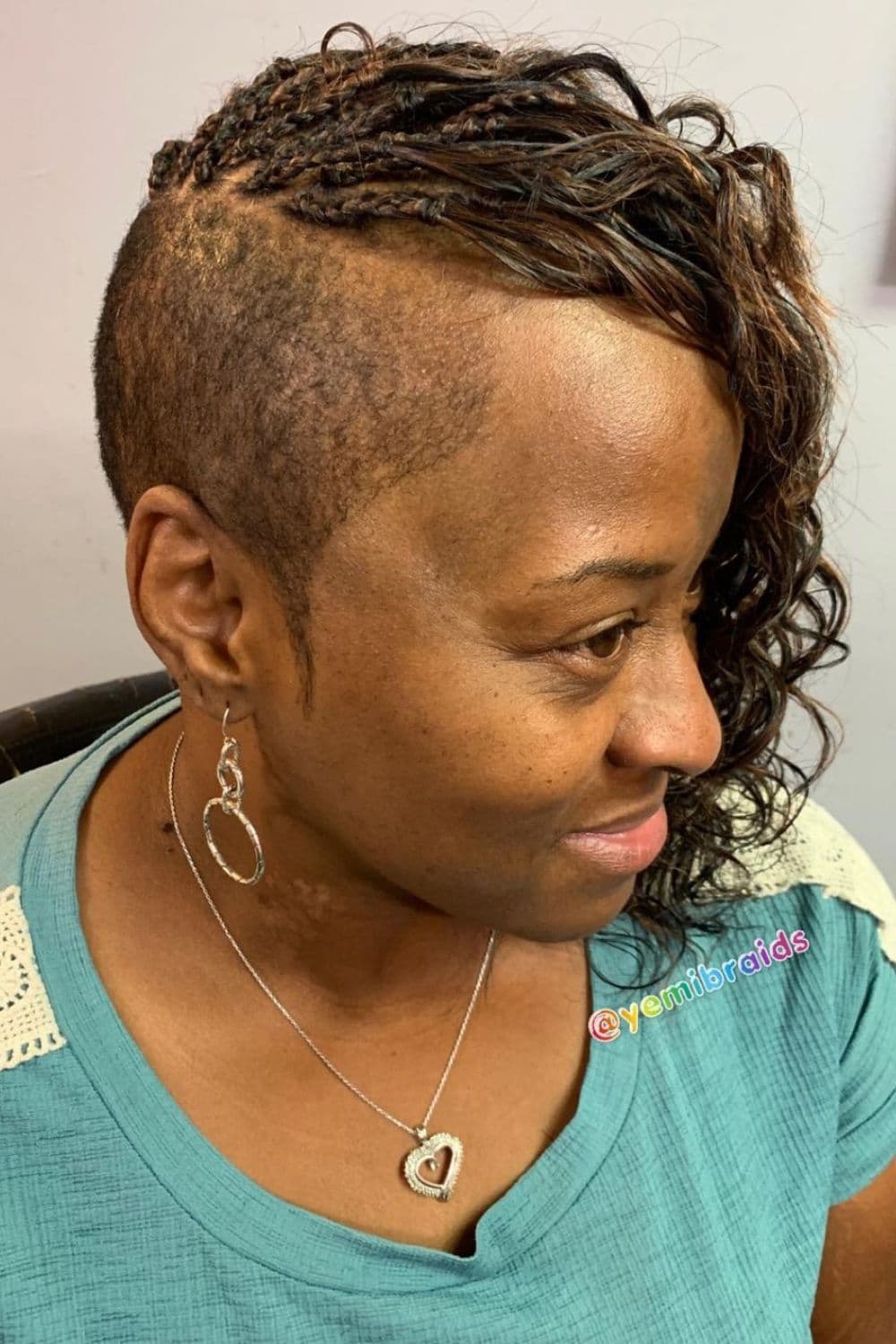 Side view of a woman with micro braids mohawk.