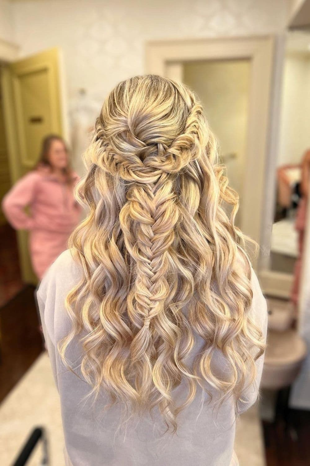 A woman with a blonde milkmaid fishtail braid.