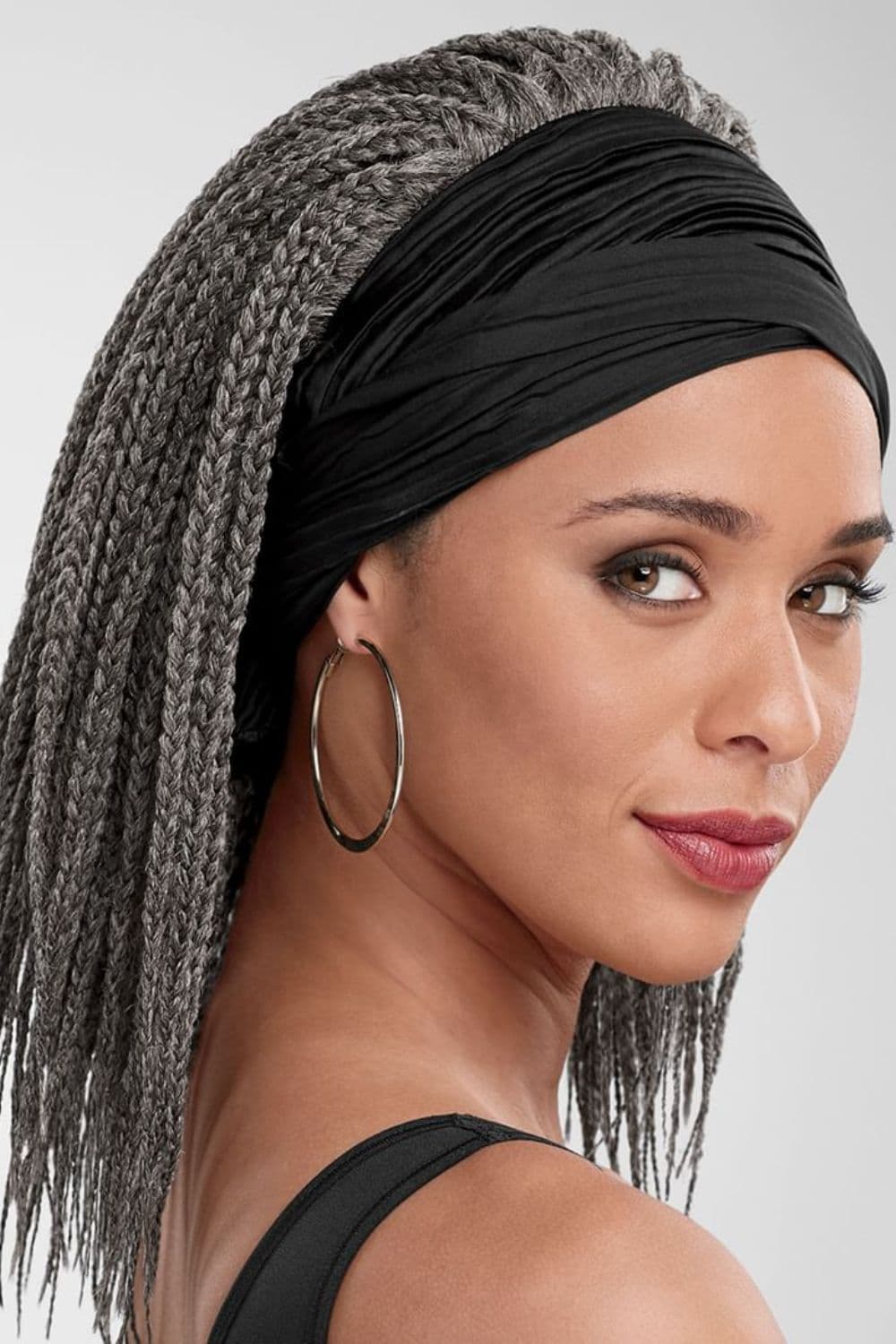 A woman with gray mini box braids and black easy-tie scarf.