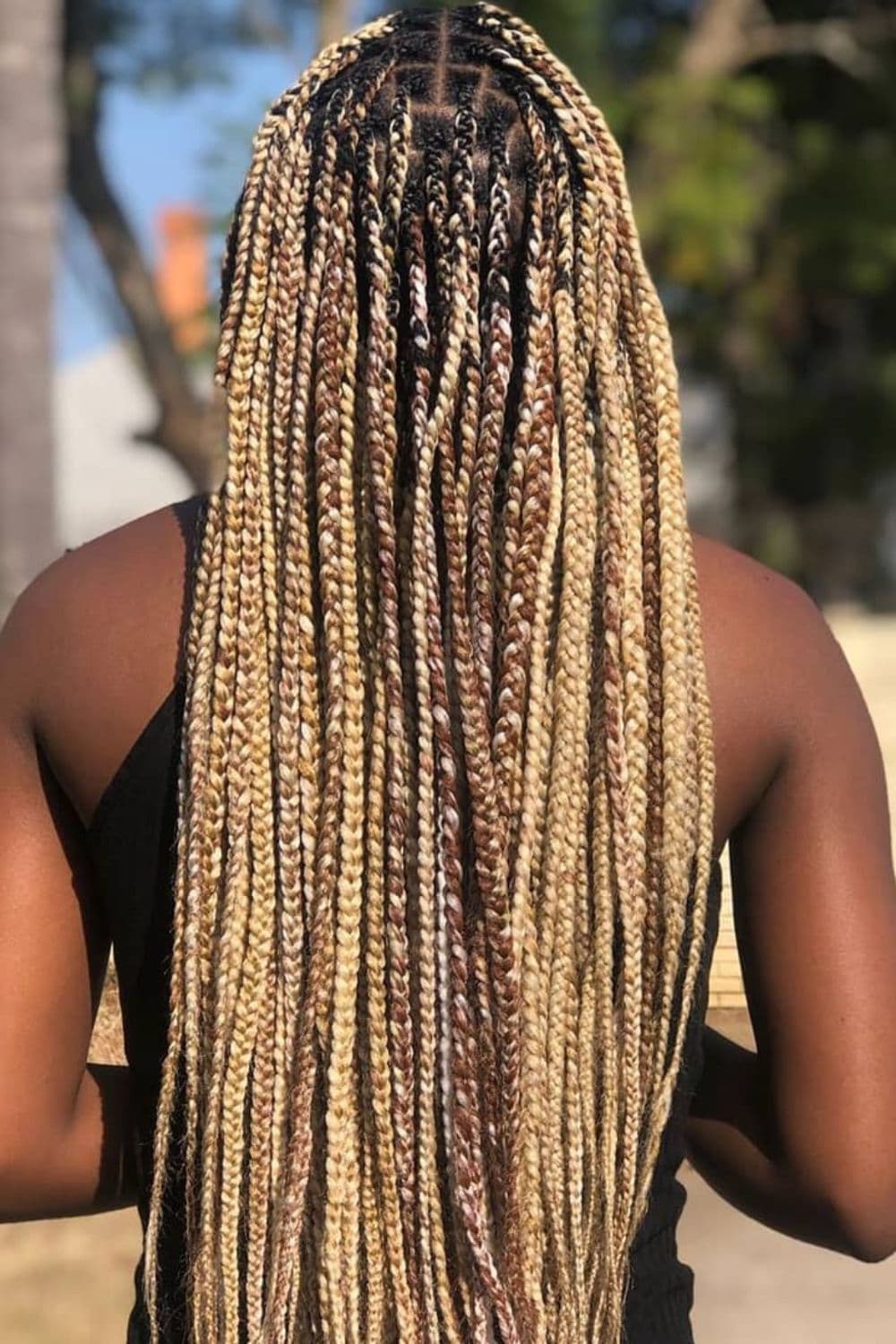 A woman's hair with mixed blonde knotless braids.