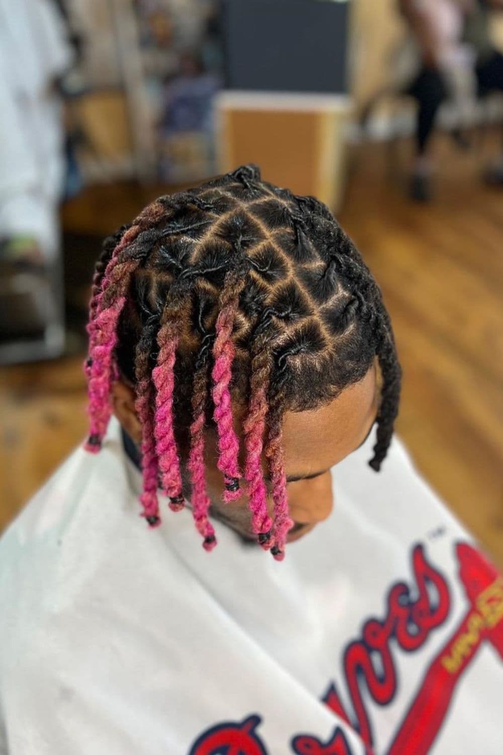A man with a pink ombre comb twist.