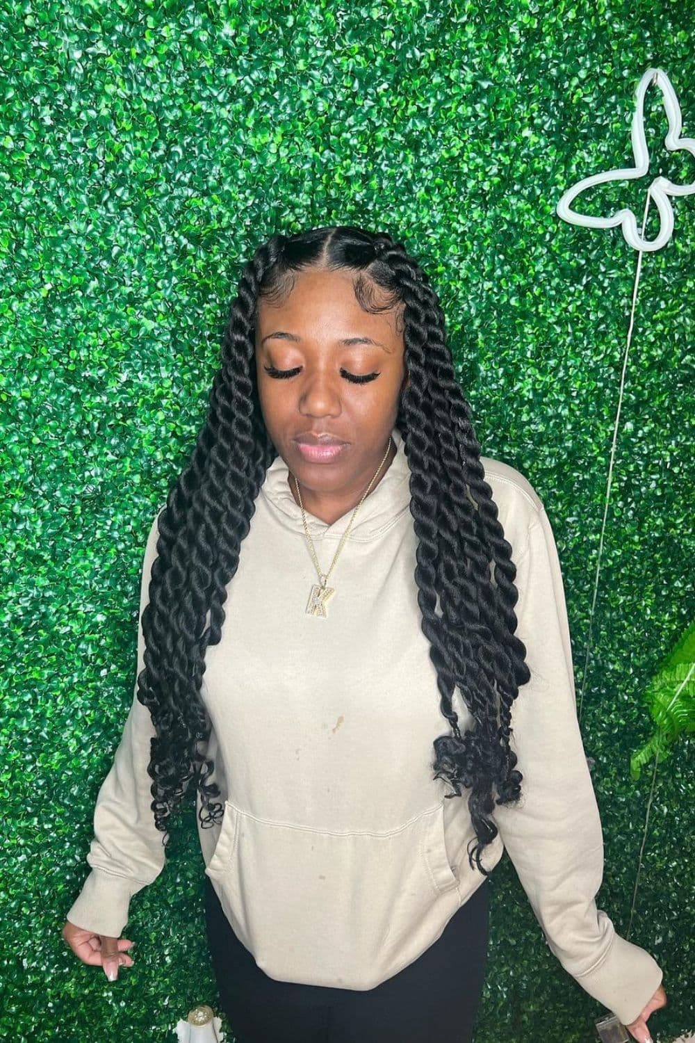 A woman with black passion twists with curly ends.