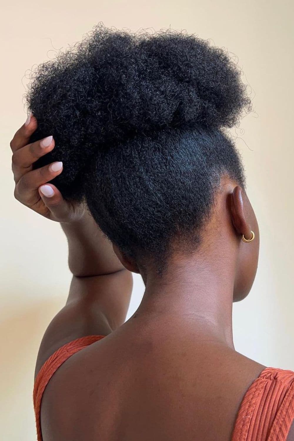 A woman with a black pineapple updo.