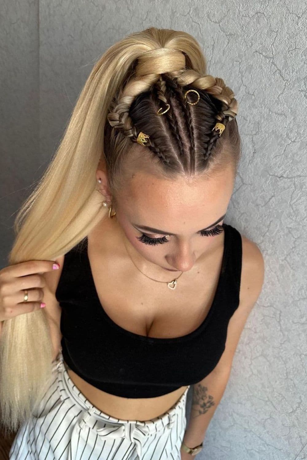 A woman with blonde ponytail with gold braids and cuffs.