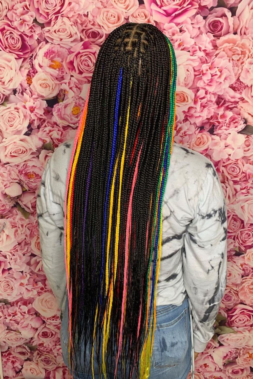 A woman with black and rainbow knotless braids.