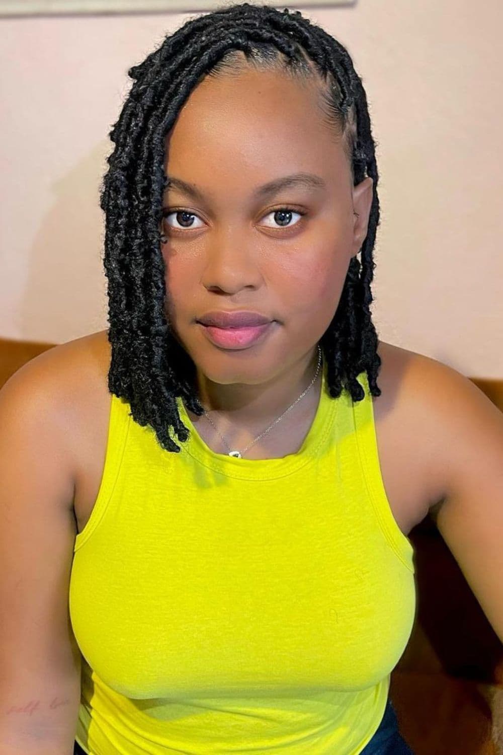 A woman with black short passion twists.