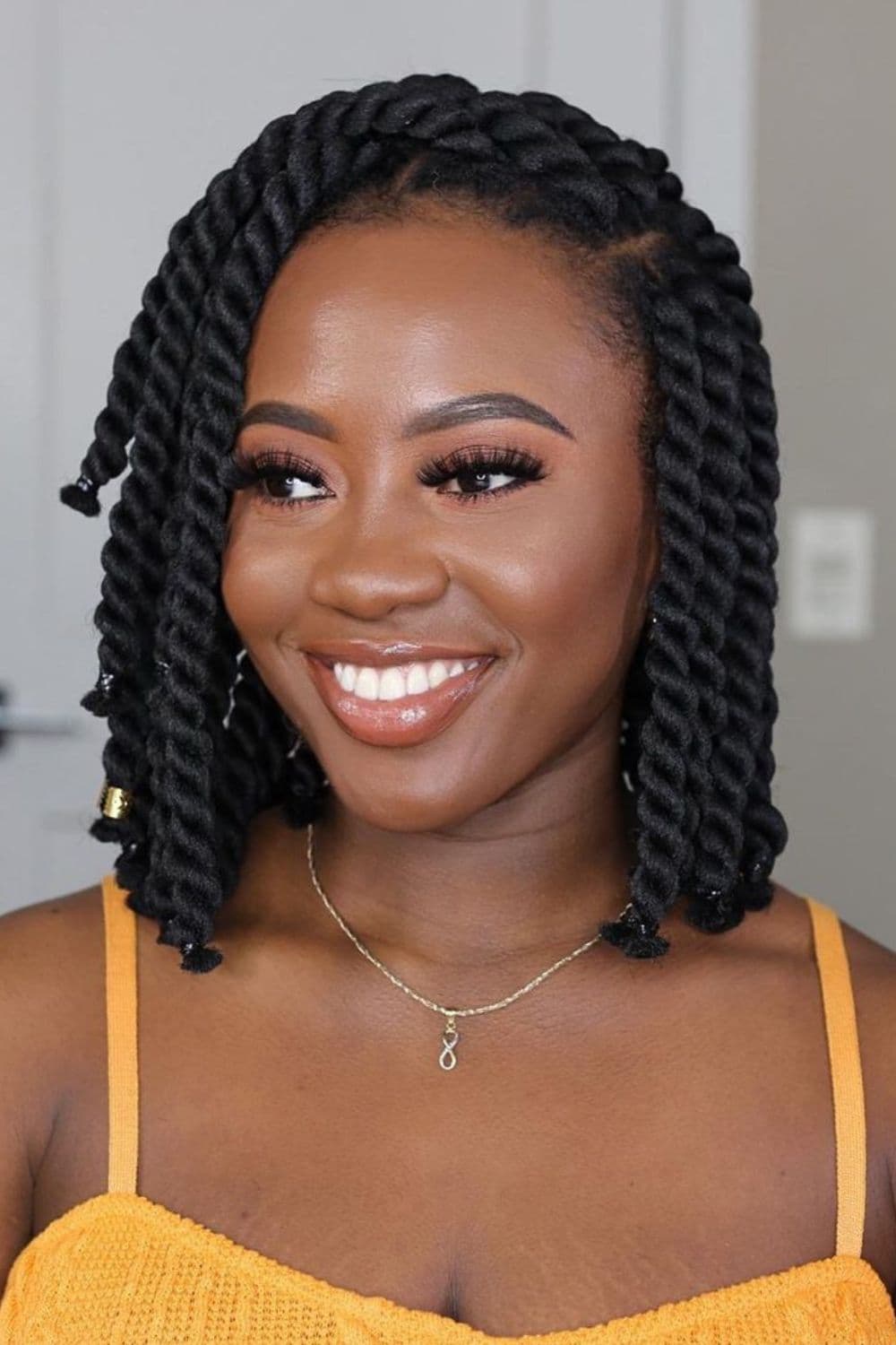 A woman with black side-parted two chunky twists.