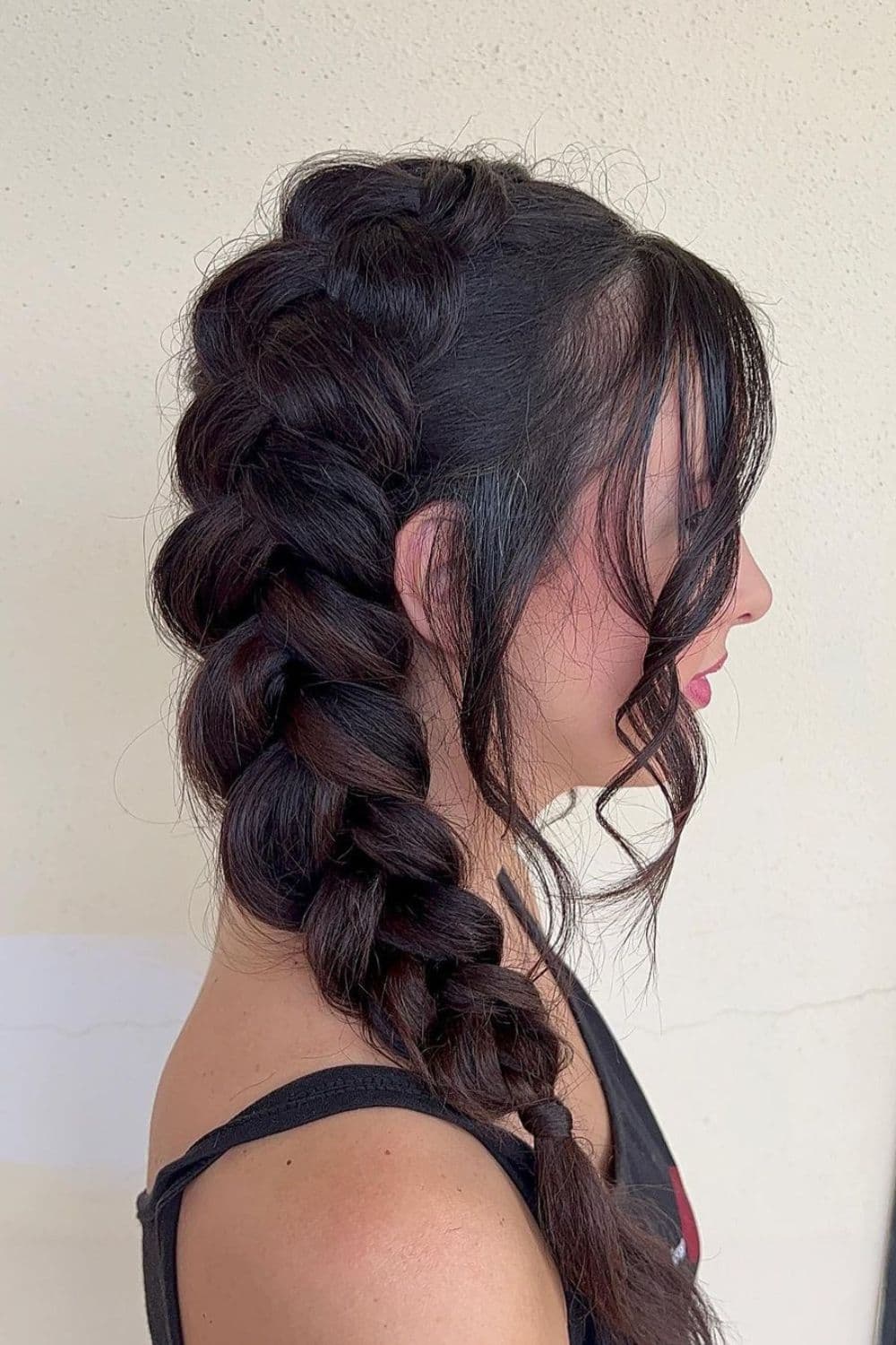 Side view of a woman with a sideways French braid.