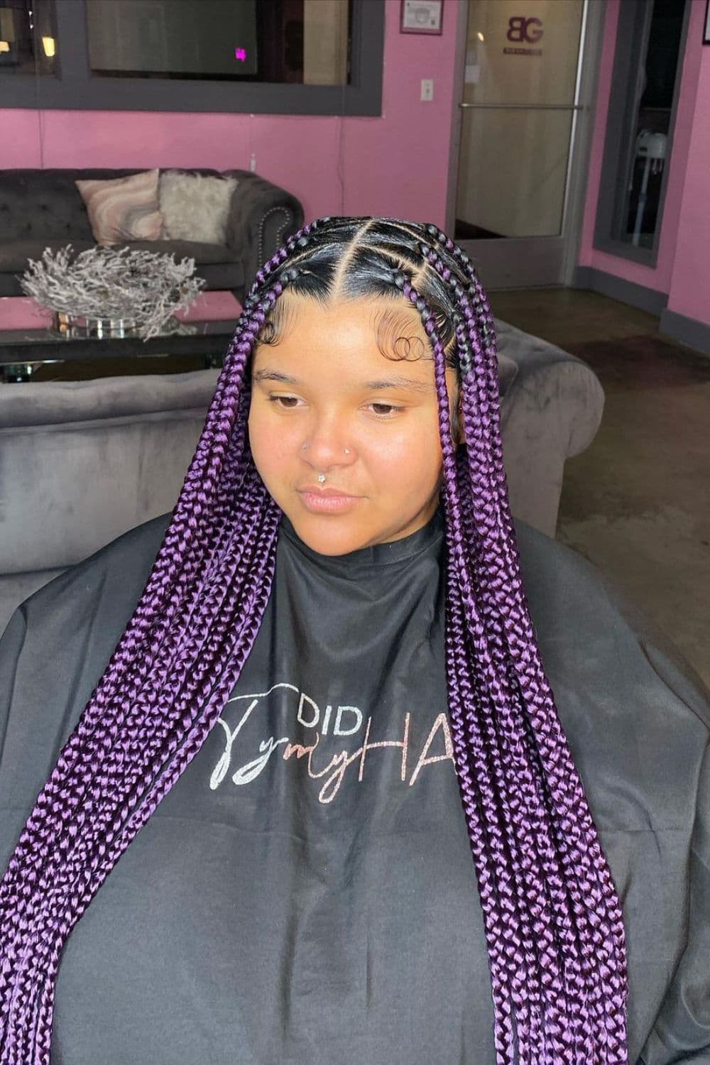 A woman with purple classic knotless braids.
