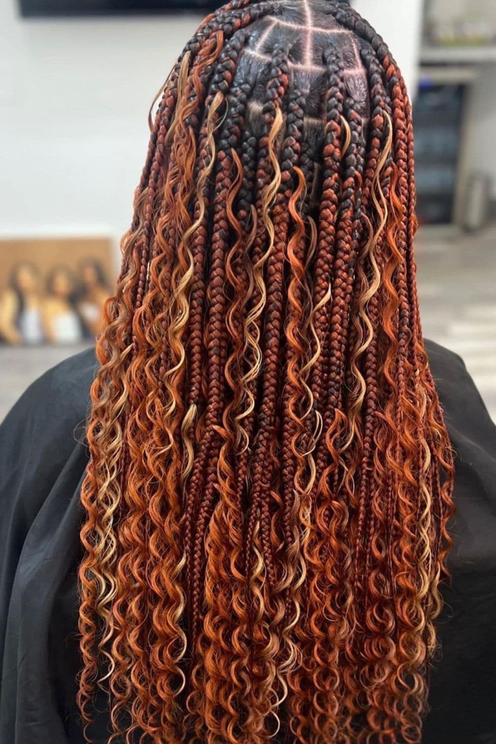 A woman with brown, blonde, and black goddess braids.