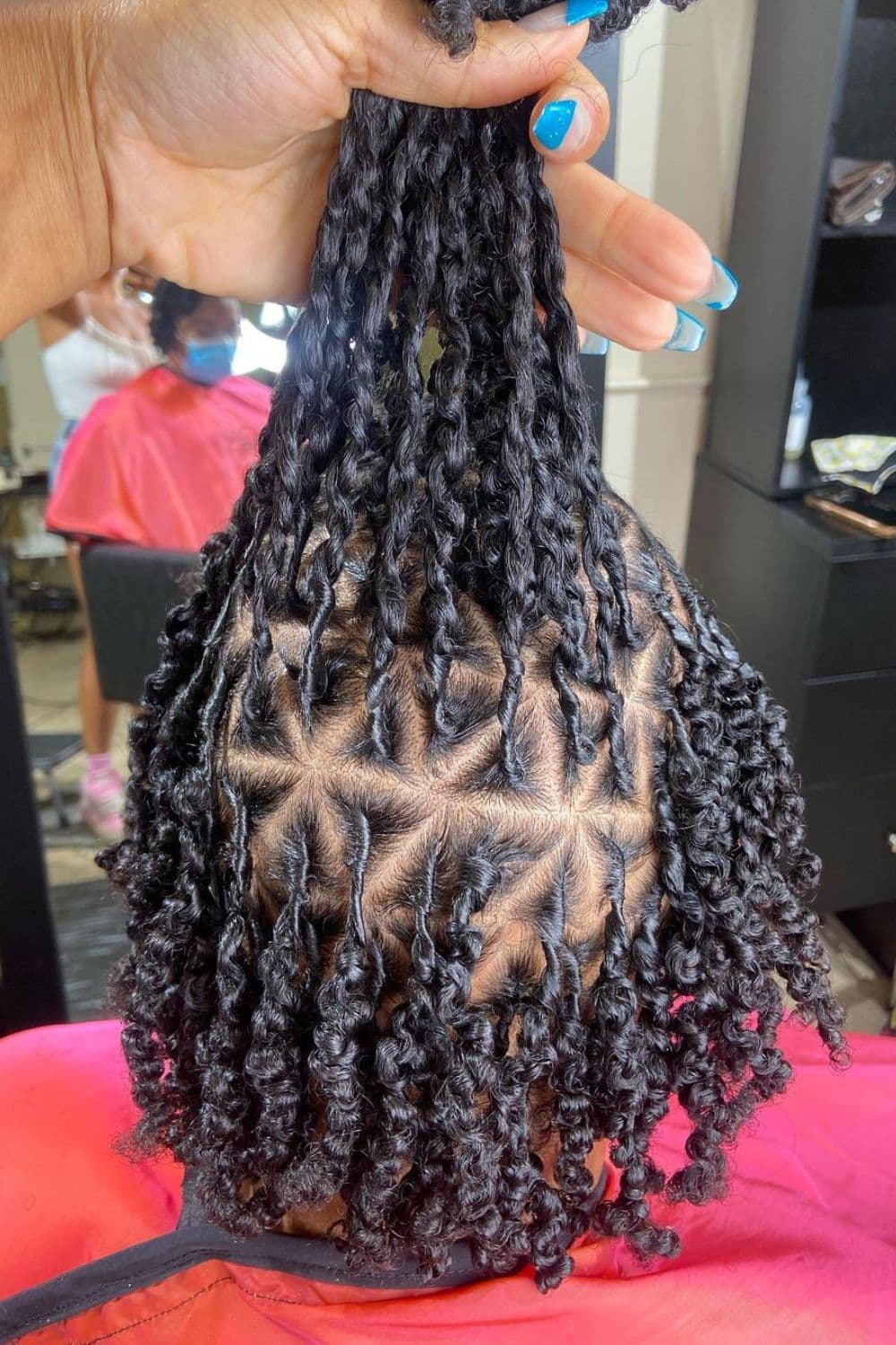 A woman with triangle part two-strand twists.