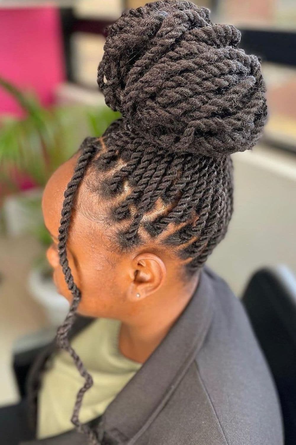 Side view of a woman with twists and updo style.