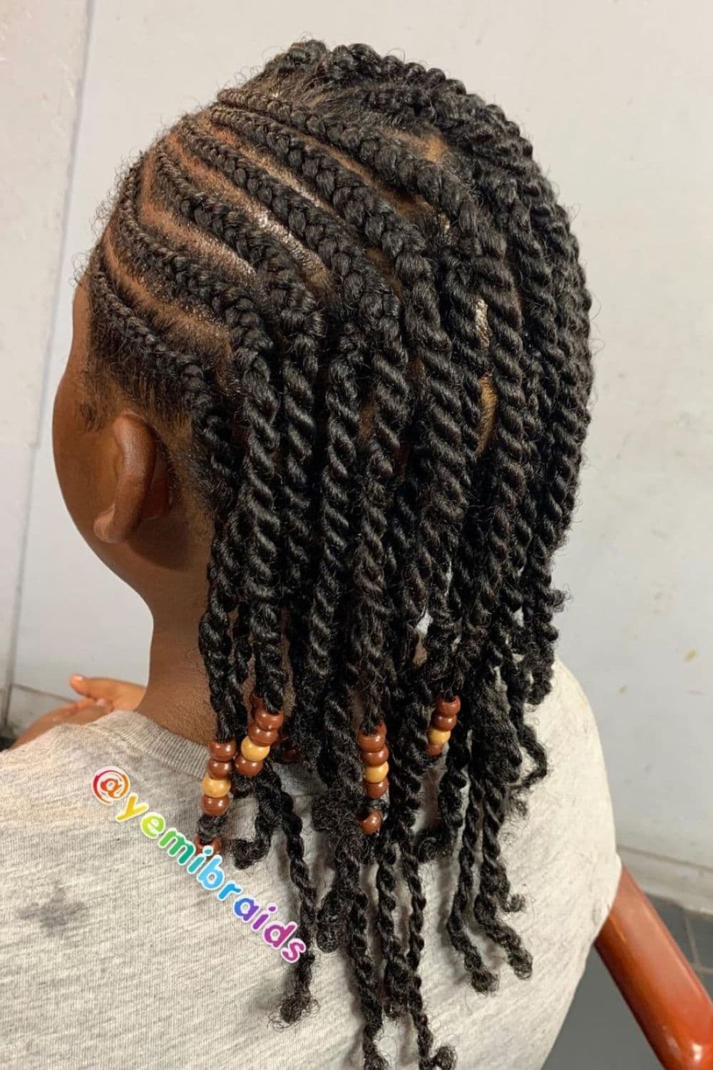 A girl with two-strand twists with cornrows.